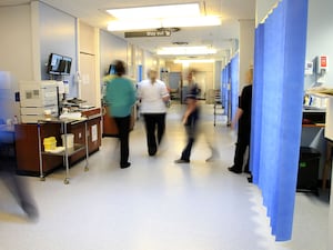 Blurred images of people walking in a hospital ward