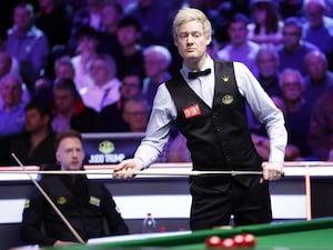 Neil Robertson in action at the UK Championship with opponent Judd Trump sitting in the background