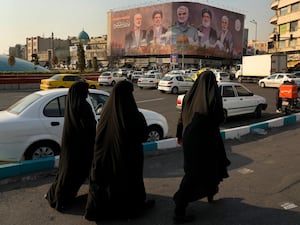 People walk in Tehran