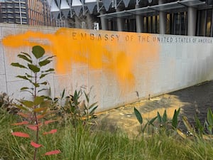 Orange paint splashed on a wall outside the US embassy in London