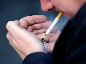 A man lighting a cigarette