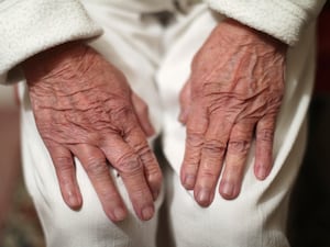 An elderly person's hands