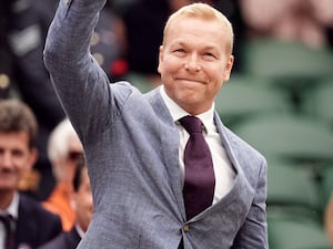 Sir Chris Hoy waves to crowds of people