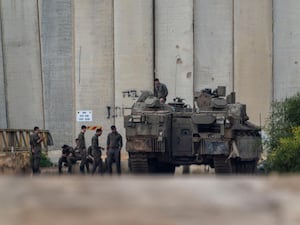 Israeli soldiers gather by the border with the Gaza Strip