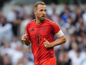 Harry Kane, wearing a red kit, in action for Bayern Munich