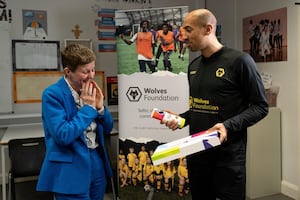 Louisa Craig, Principal of Our Lady & St Chad Academy, is surprised by Wolves Foundation ambassador Karl Henry.