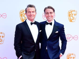 Bradley and Barney Walsh smiling on the red carpet