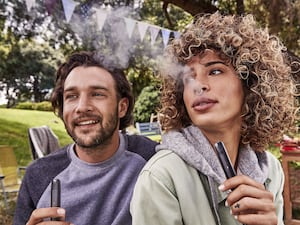 A man and woman vaping