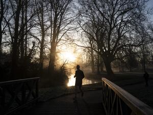 A jogger running in a cold park