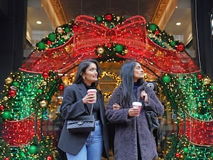 Shoppers in Piccadilly Arcade, Birmingham do some Christmas shopping in 2022