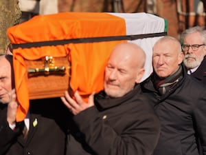 Former Sinn Fein president Gerry Adams (right) walks behind the coffin of Brendan ‘Bik’ McFarlane as it leaves his family home on Cliftonville Road, Belfast