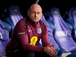 England manager Lee Carsley looks on from his seat in the dugout