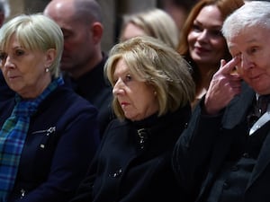 Moira Salmond flanked by two people, seated