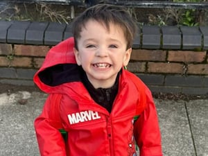 Smiling little boy in a red coat