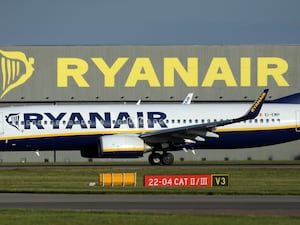 Ryanair plane seen in profile before a Ryanair hangar