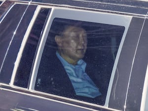 South Korean President Yoon Suk Yeol in the back seat of a car