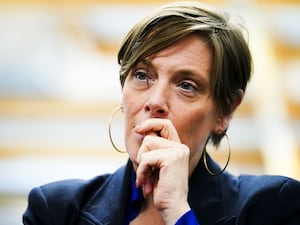 Home Office minister Jess Phillips raises a hand to her mouth