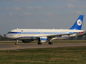 An Azerbaijan Airlines plane on an airport runway