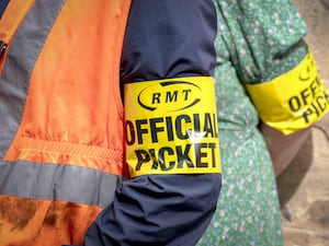 RMT official picket sign on the arm of a striking rail worker