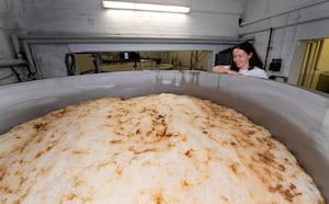 Alice Batham checks on the progress of the final stages of the ale, before it's barrelled.