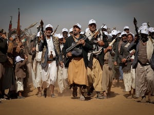 Houthi fighters march during a rally of support for the Palestinians