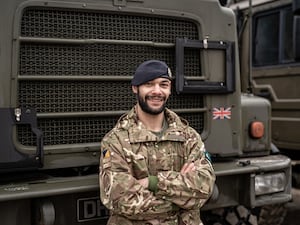 Lance Corporal Lee Moulton poses in uniform before a tanker