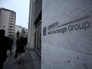 People walk past the London Stock Exchange