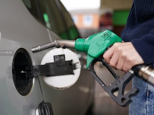 Motorist filling up their car with petrol