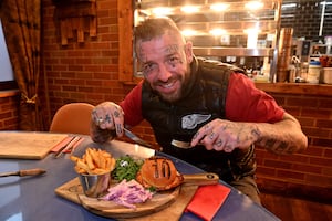 Lockside Steakhouse Stourbridge owner Matt Lemm tucks into the 'Bellingham Burger.' 