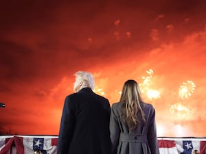 The backs of Donald and Melania Trump watching fireworks