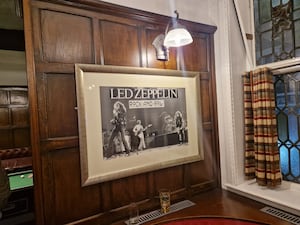 A photograph of Led Zeppelin adorns one of the walls in the pub