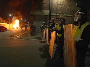 Riot police lined up behind shields amid Southport disorder