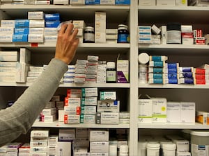 A pharmacist stocking shelves