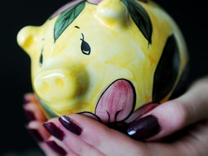 Someone holding a piggy bank