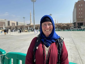 Alice Morrison smiling in red top and blue headscarf