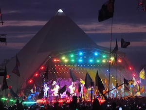 A Glastonbury Festival stage lit up