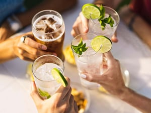 Group of people celebrating toasting with cocktails