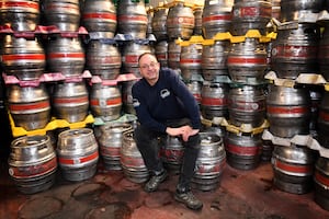 Nick Davis gets comfortable on some of the many kegs of beer produced by Hobsons