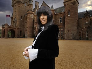 Claudia Winkleman in front of a castle