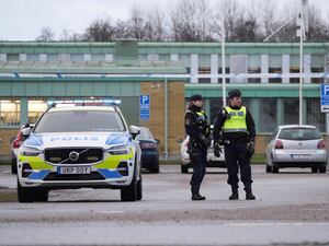 Police officers stand guard near the scene of a shooting at an adult education center on the outskirts of Orebro