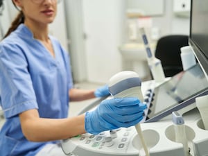 Gynaecologist uses an ultrasound to evaluate a woman's reproductive health in a clinic