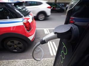 An electric Mini plugged into a public Pod Point charging point