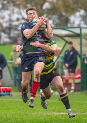 Kieran Higgins is tackled in mid-air during Lichfield's victory on Saturday (Picture: Jim Wall)