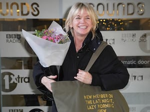 Zoe Ball holds a bouquet of flowers after hosting her last Radio 2 breakfast show