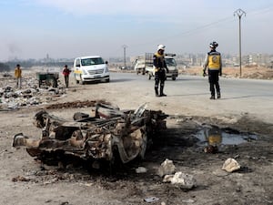 People inspect the wreckage from the blast