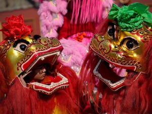 Chinese artists perform a lion dance