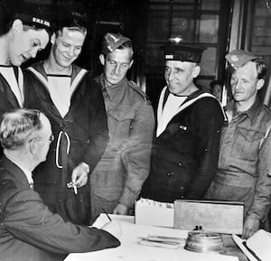 Bob Smith is seen handing out the pocket money from the Express & Star's Darlaston Comforts Fund to sailors and soldiers involved in the Dunkirk evacuation