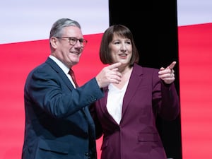 Keir Starmer and Rachel Reeves point towards the audience from the stage at the 2024 Labour Party conference