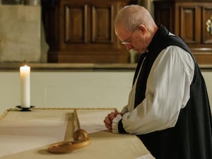 Archbishop of Canterbury, the Most Reverend Justin Welby, laying down the Gregory Crozier on the altar during a service of Evensong at Lambeth Palace Chapel