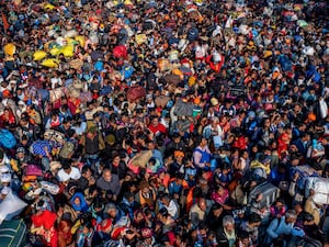 Indian Hindu devotees arrive for a holy dip at Sangam